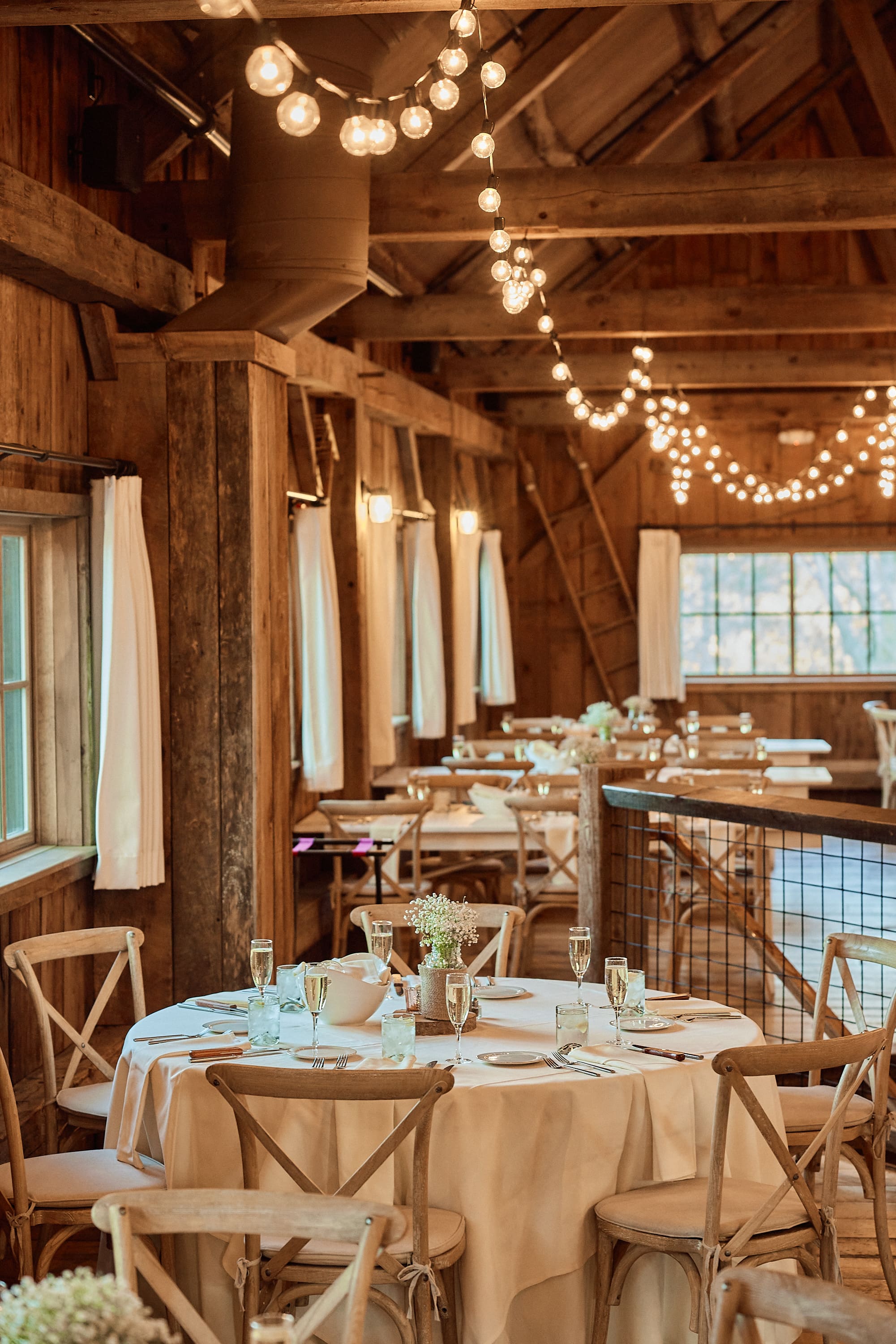 Elegant wedding reception table setting in a rustic Boston barn